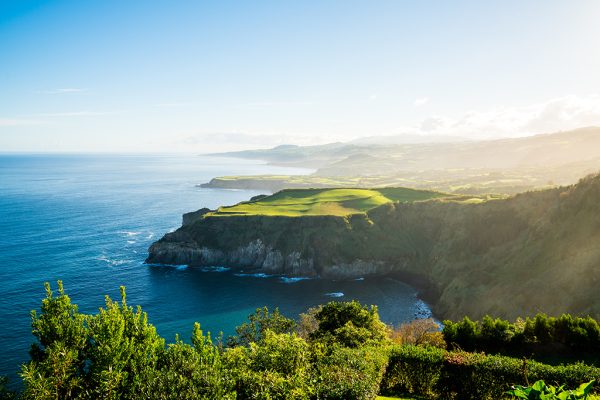 An amazing view of a green cliff near the sea in the Azores archipelago, Portugal