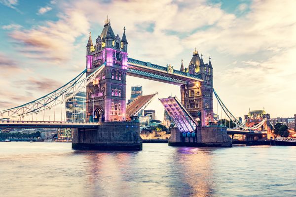 Tower Bridge in London, the UK at sunset. Drawbridge opening on River Thames